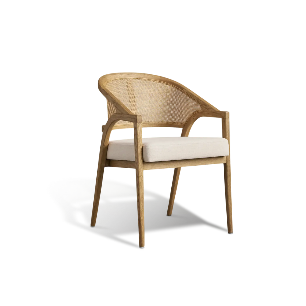 Wooden chair with wicker backrest and white cushion on a white background
