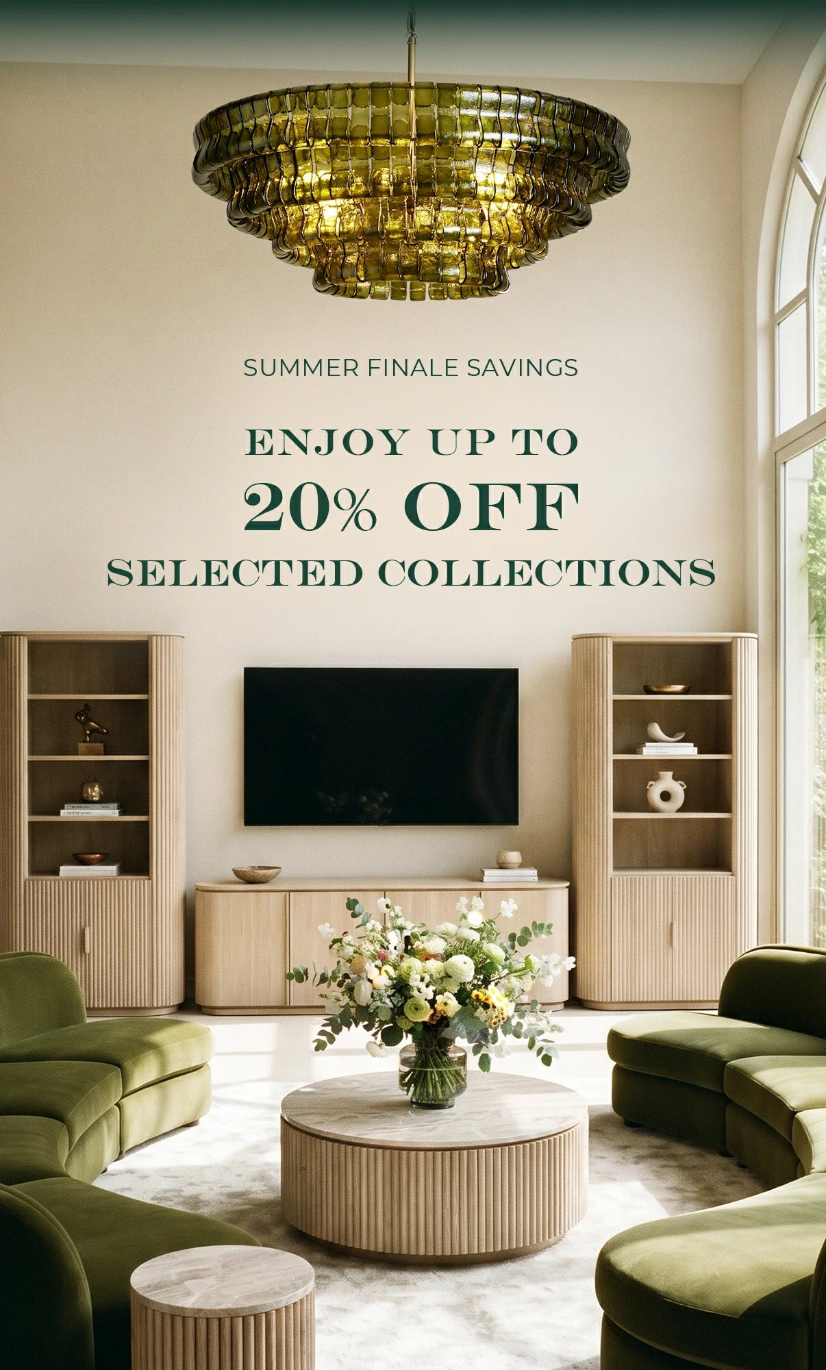 A luxury living room scene featuring olive green velvet sectional sofas, a round ribbed wood coffee table with a floral centerpiece, light wood shelving, and a large gold chandelier. A promotional text overlay reads 'SUMMER FINALE SAVINGS ENJOY UP TO 20% OFF SELECTED COLLECTIONS'.